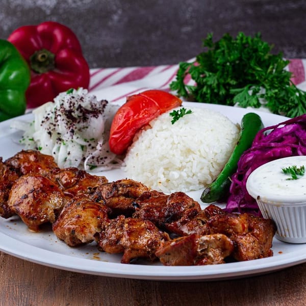 Marash Turkish Cuisine's chicken shish kebab with rice, red cabbage, onion salad, and yogurt sauce.